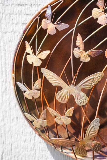 Decorative wall art with metal butterflies on a textured surface
