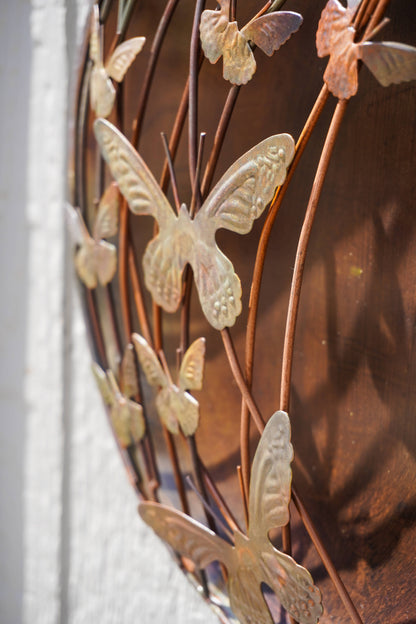 Metal wall art with butterfly designs on a textured surface