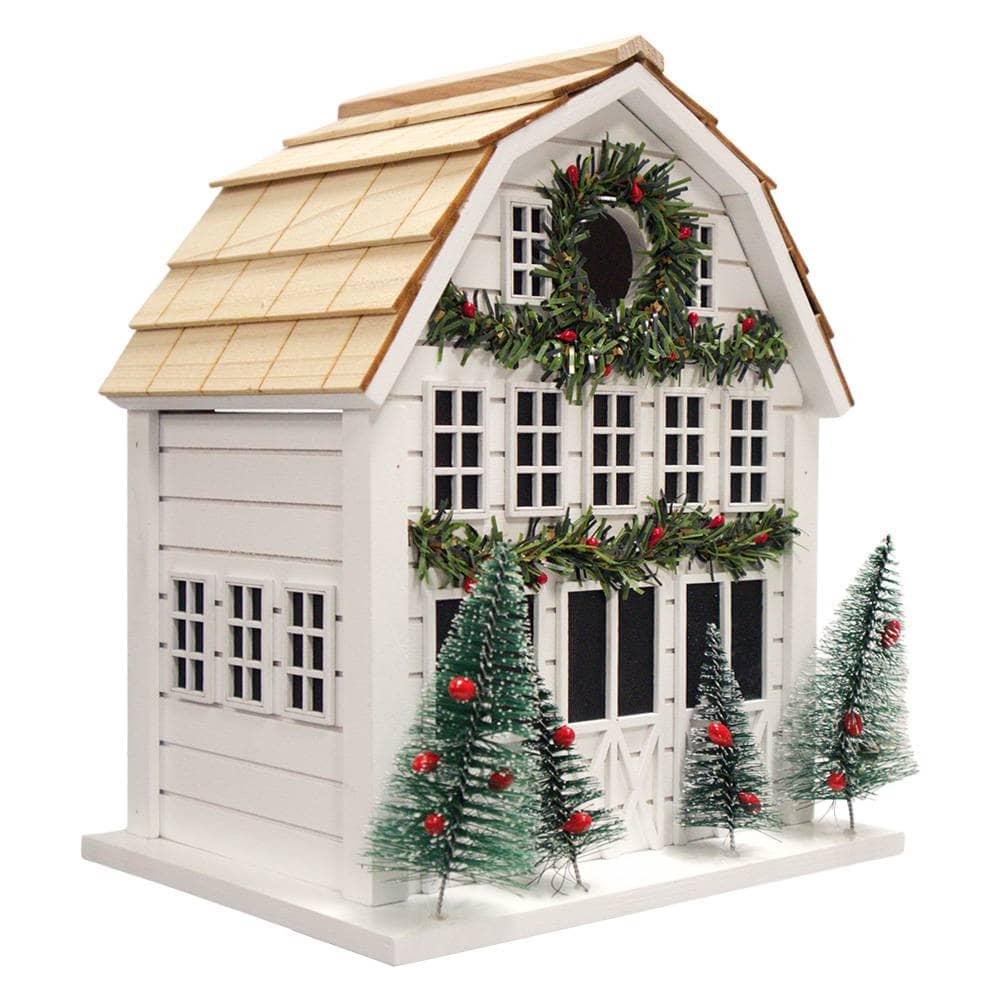 Decorative birdhouse with Christmas trees and garland on a white background