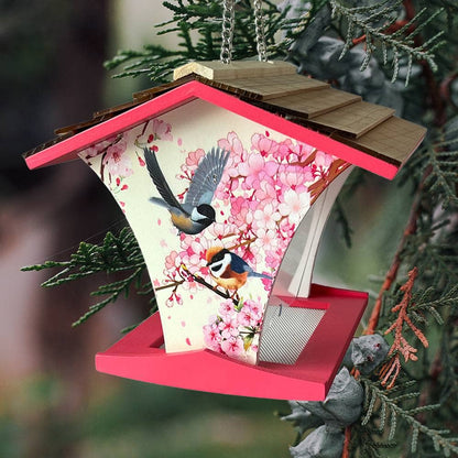 Decorative birdhouse with cherry blossoms and birds on a branch, hanging from a tree.