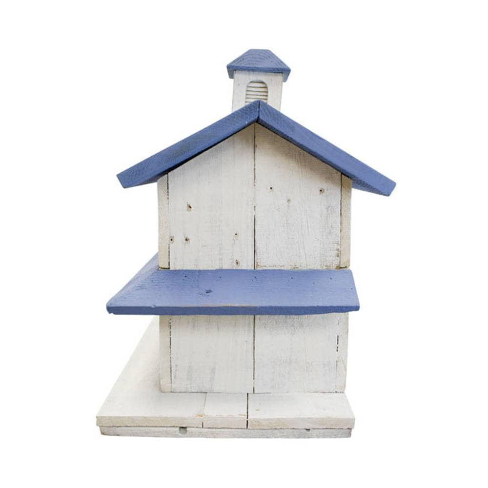 A rustic wooden house-shaped birdhouse with a weathered white finish and blue painted roof and cupola, isolated on a white background.