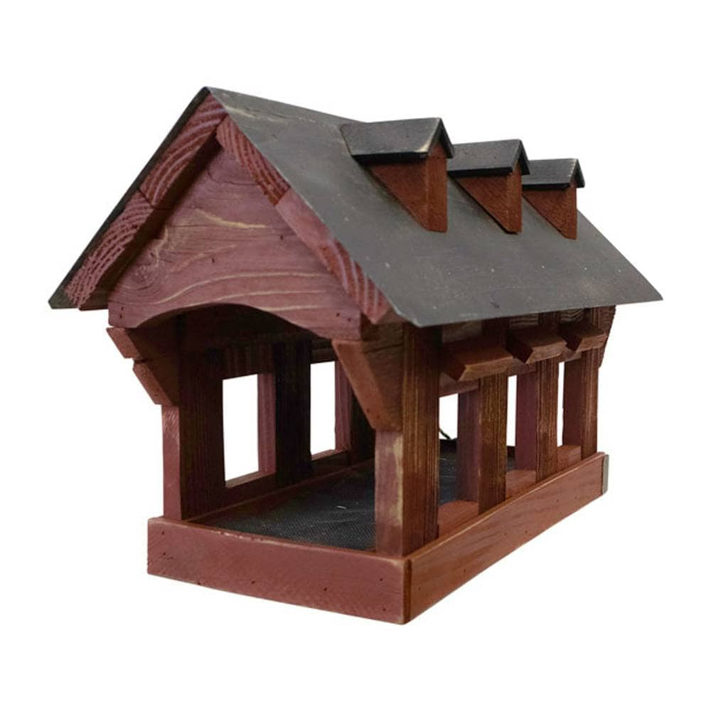 Wooden bird feeder with a brown roof on a white background