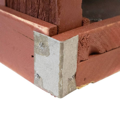 Close-up of a wooden corner joint with a silver metal L-bracket secured by screws, set against a plain white background.