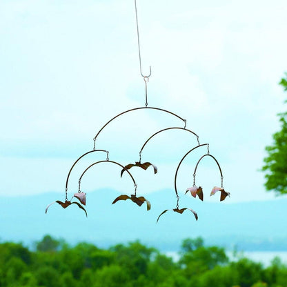 Rustic metal hanging mobile with layered arched arms and small copper-toned bat figurines suspended by chains