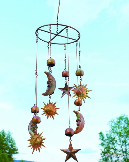 Rustic metal wind chime mobile with copper-toned sun, crescent moon, star, and bell charms hanging from an oval ring